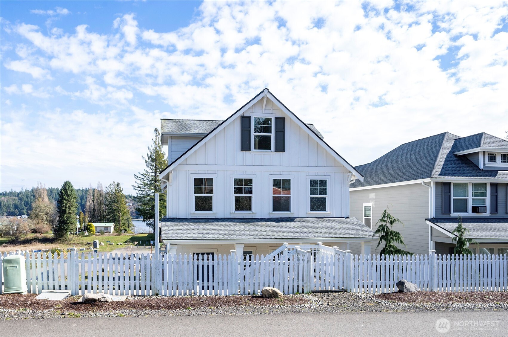10 East Compass Lane Allyn, WA 98524 - Photo 3 of 35 a house view with a garden and wooden fence