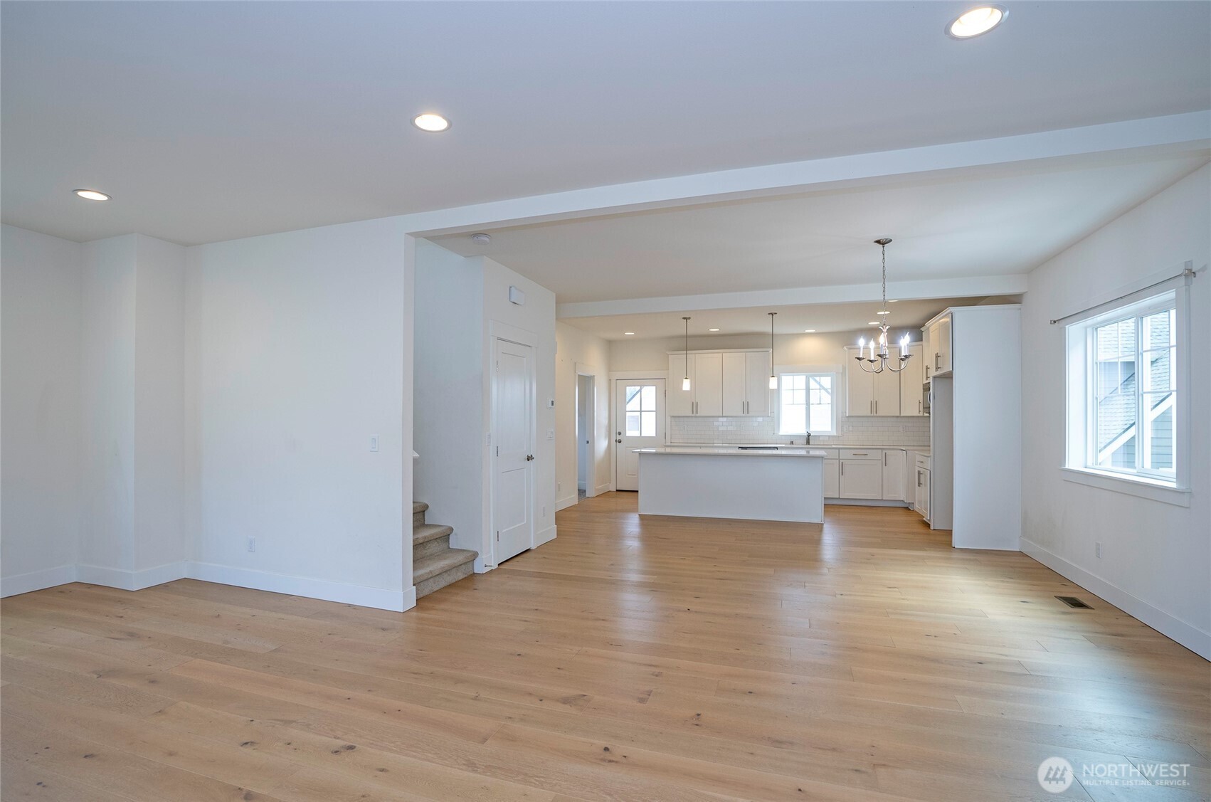 10 East Compass Lane Allyn, WA 98524 - Photo 9 of 35 an empty room with wooden floor and windows