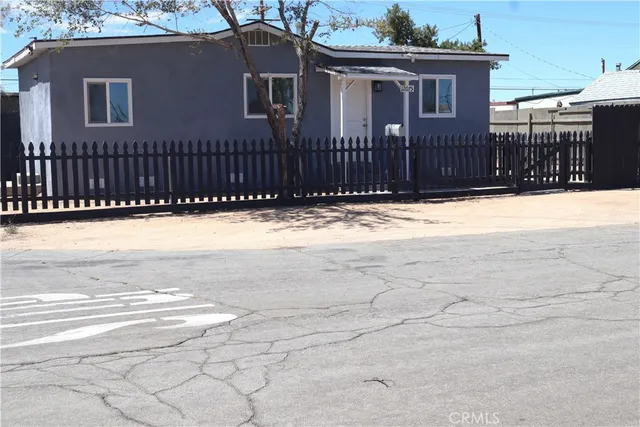 a view of a house with a wooden fence