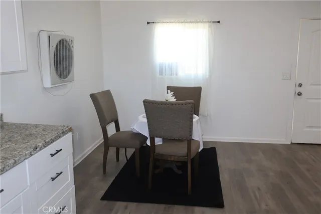 a view of a room with furniture and wooden floor