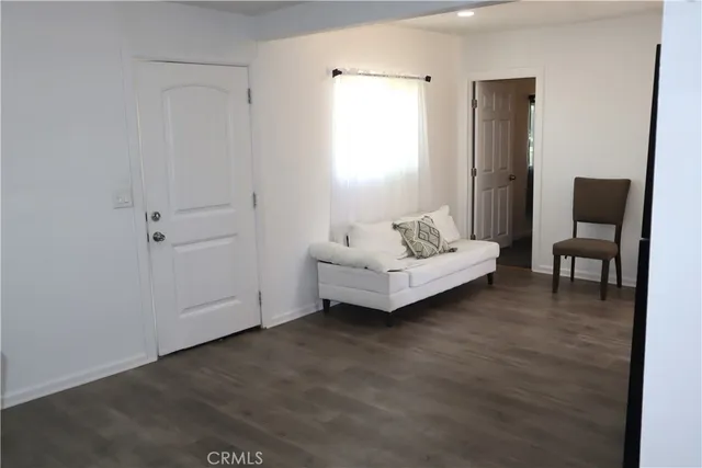 a spacious bedroom with a bed and a chair