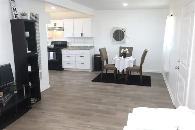 a view of a dining room with furniture and wooden floor