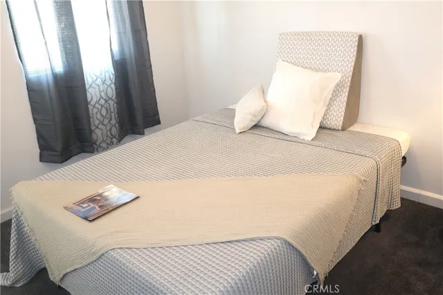 a bedroom with a bed and a mirror