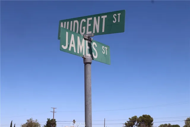 a street sign on a wall next to a road