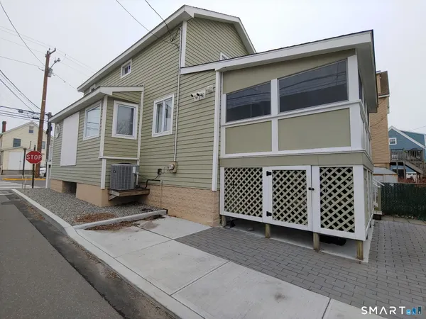 a white toilet sitting next to a bathroom sink and a shower