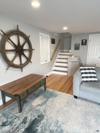 a living room with a bed furniture and a window