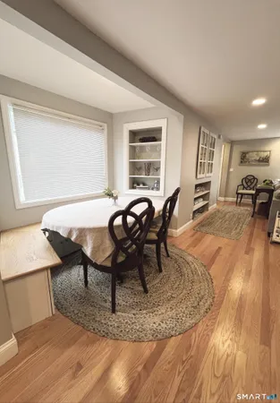 a view of a dining room with furniture and wooden floor