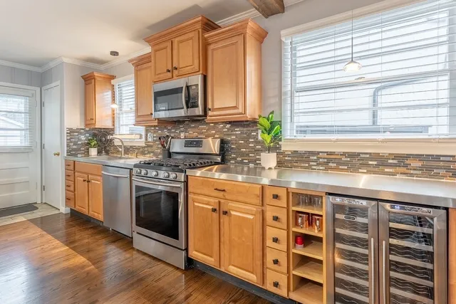 a kitchen with stainless steel appliances a stove sink and microwave