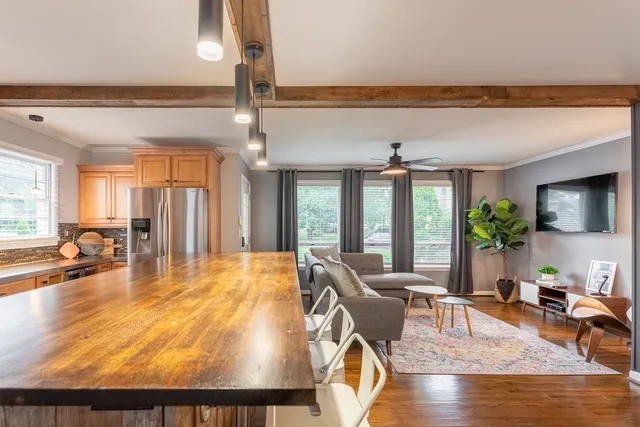 a living room with dining room and wooden floor