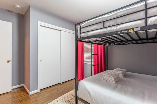 a bed sitting in a bedroom next to a window