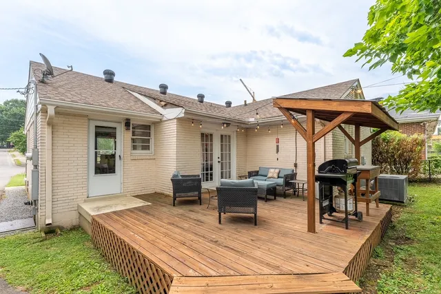 a view of a dinning table and chairs in patio of the house