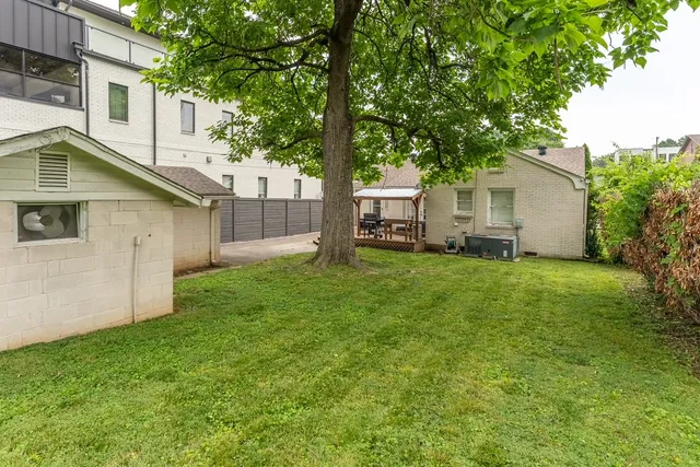 a view of backyard of house with green space