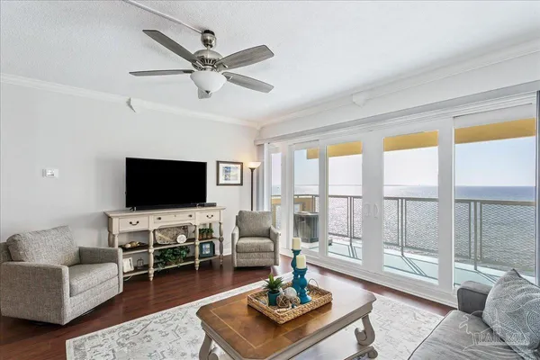 a living room with furniture a flat screen tv and a large window