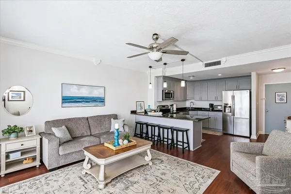 a living room with furniture kitchen view and a table