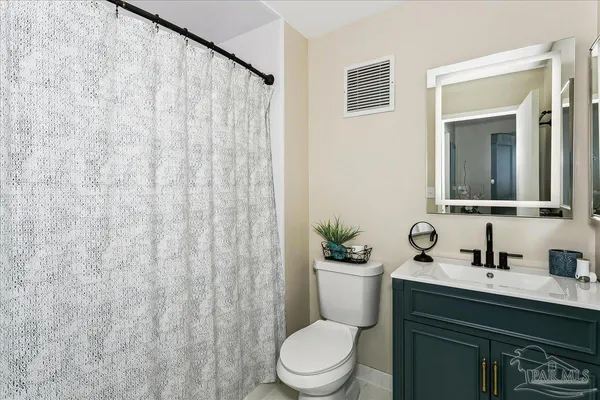 a bathroom with a toilet a sink and a mirror