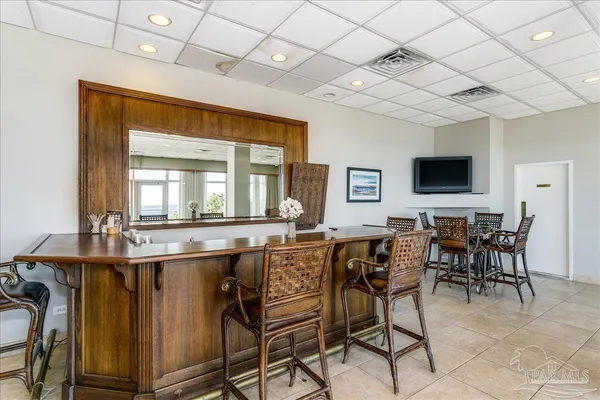 a room with pool table and windows