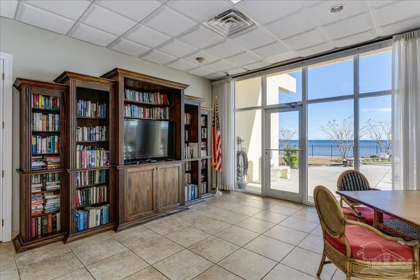 a living room with furniture and large windows