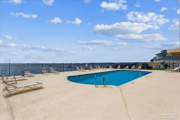 a view of a swimming pool with a lounge chair