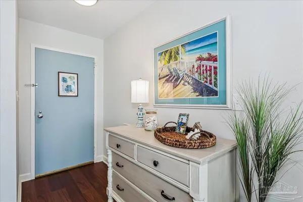a room with painting on wall and a wooden floor