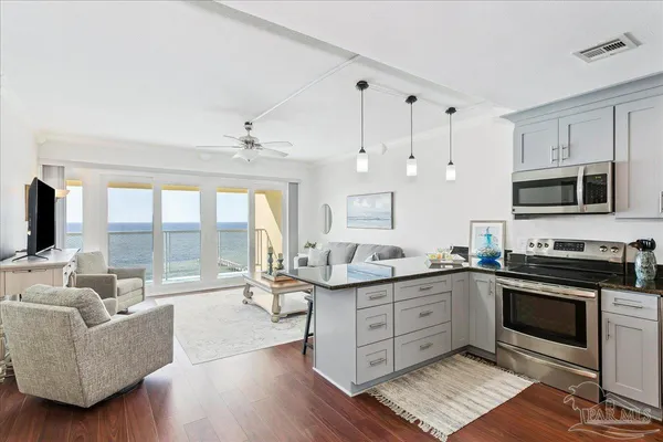 a kitchen with stainless steel appliances granite countertop a stove and cabinets