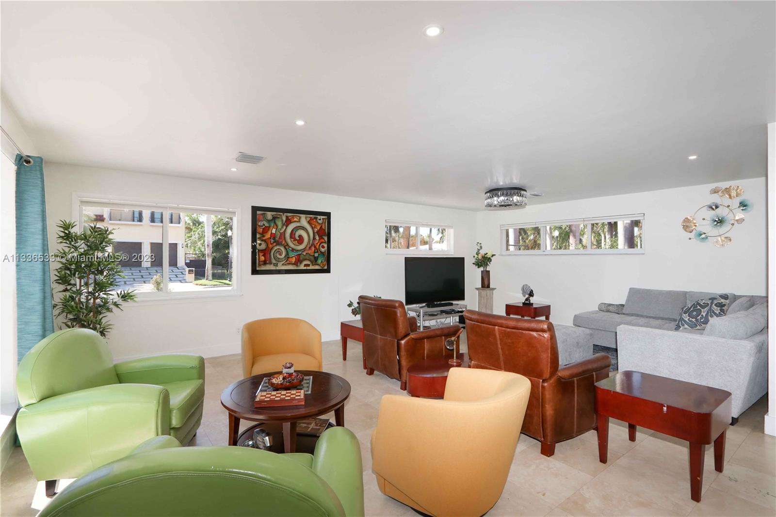 735 Tyler Street Hollywood, FL 33019 - Photo 12 of 35 a living room with furniture a window and a flat screen tv