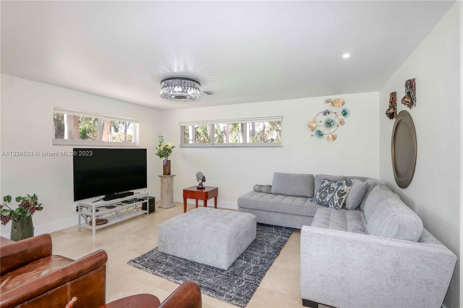 735 Tyler Street Hollywood, FL 33019 - Photo 14 of 35 a living room with furniture and a flat screen tv