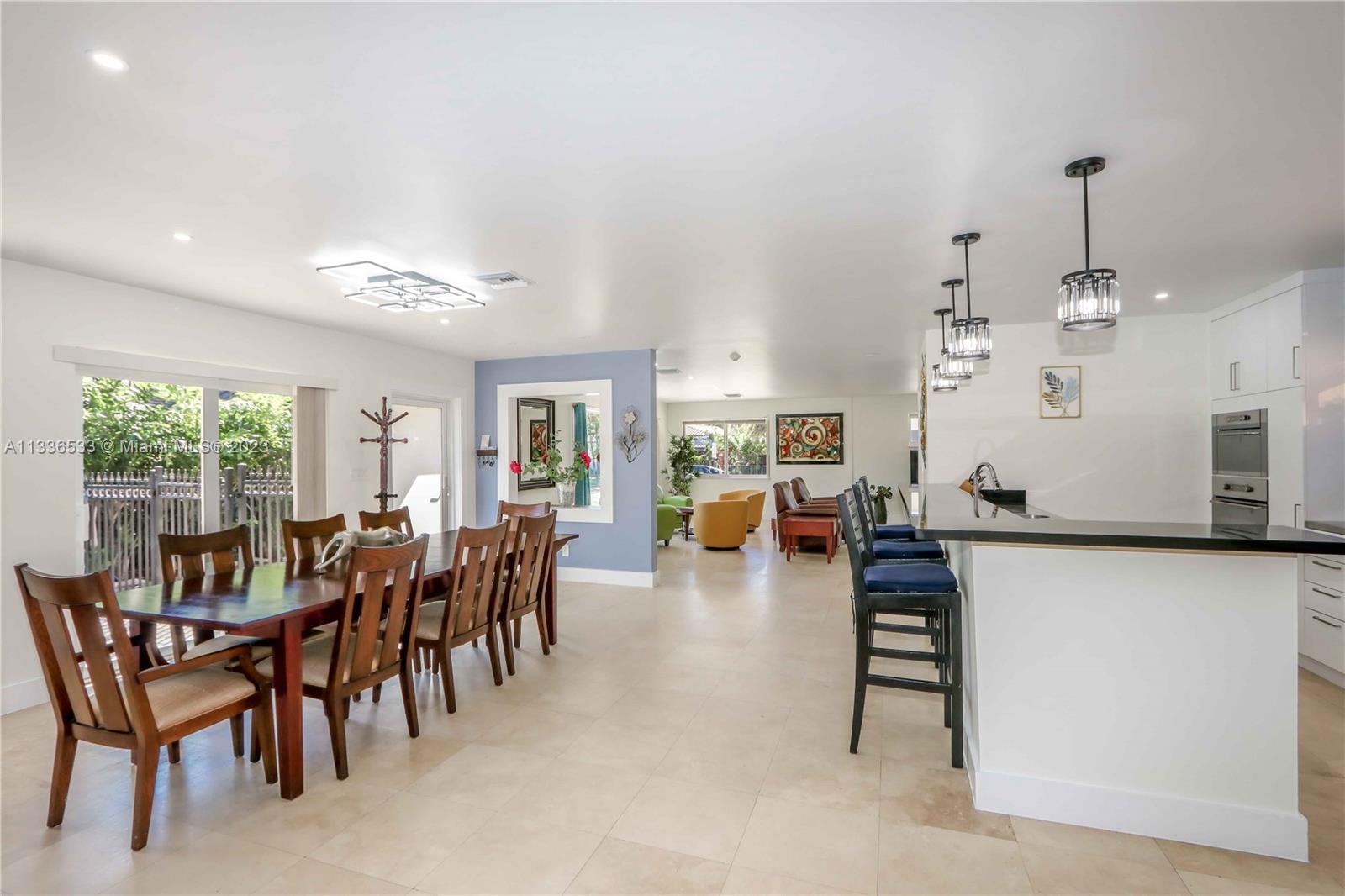 735 Tyler Street Hollywood, FL 33019 - Photo 17 of 35 a view of a dining room and livingroom with furniture wooden floor and a rug