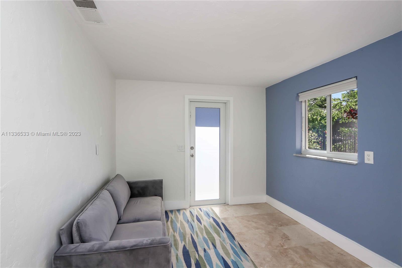 735 Tyler Street Hollywood, FL 33019 - Photo 31 of 35 a living room with furniture and a window