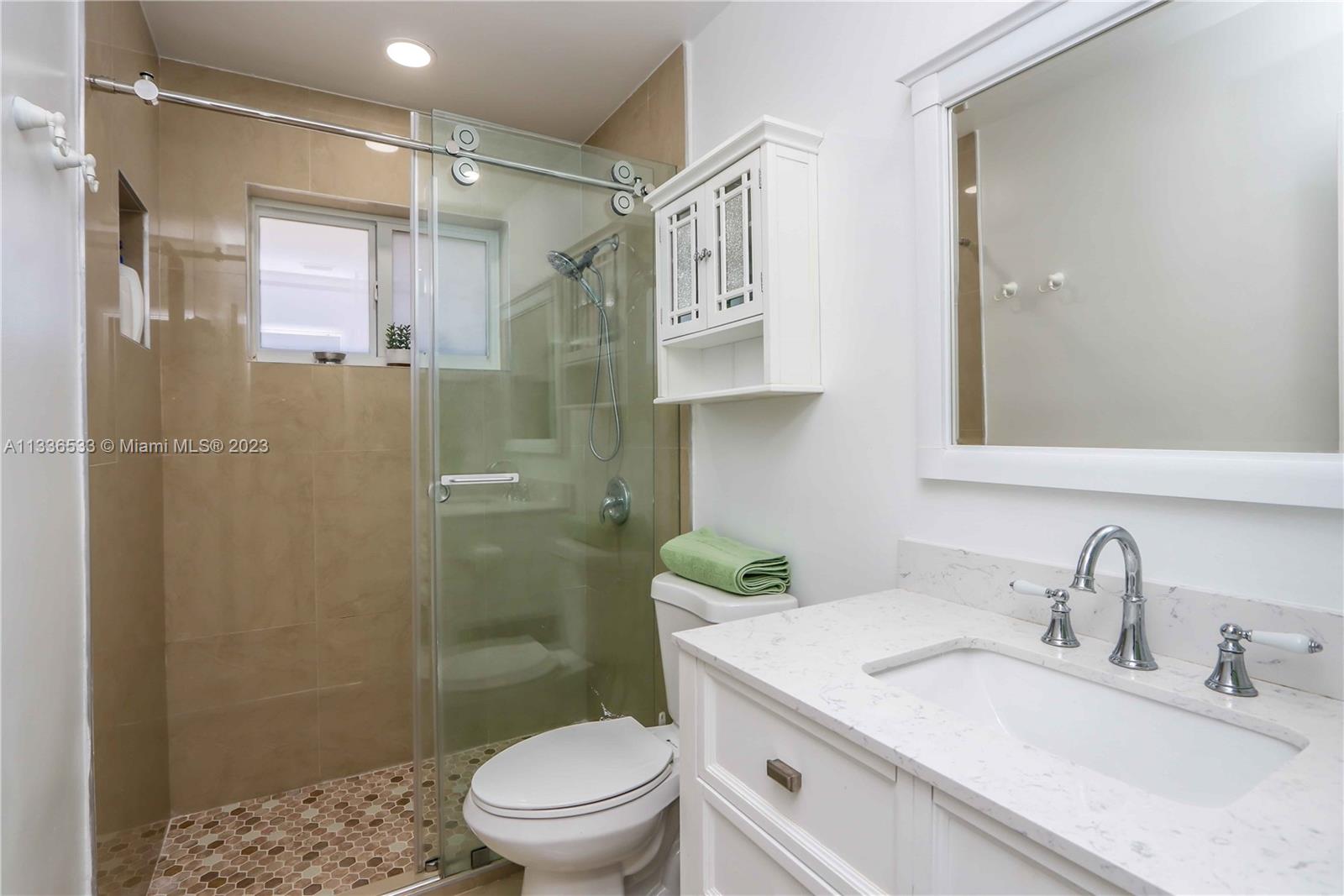 735 Tyler Street Hollywood, FL 33019 - Photo 34 of 35 a bathroom with a sink toilet and shower