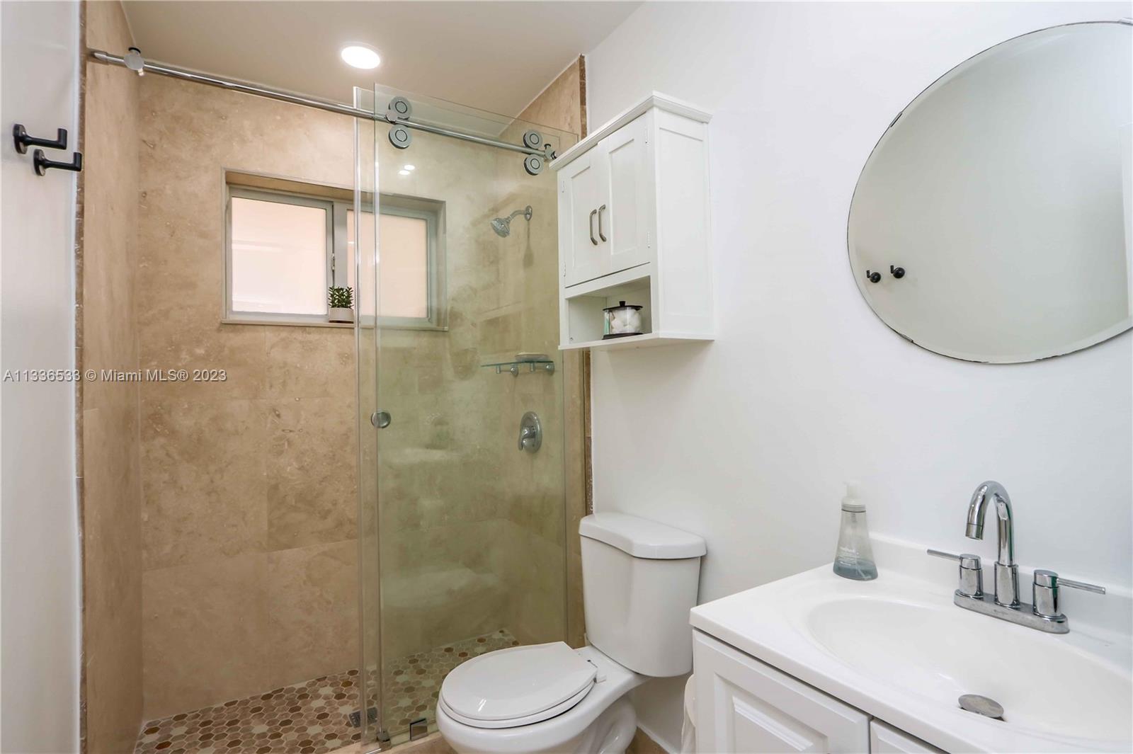 735 Tyler Street Hollywood, FL 33019 - Photo 35 of 35 a bathroom with a sink a toilet and shower