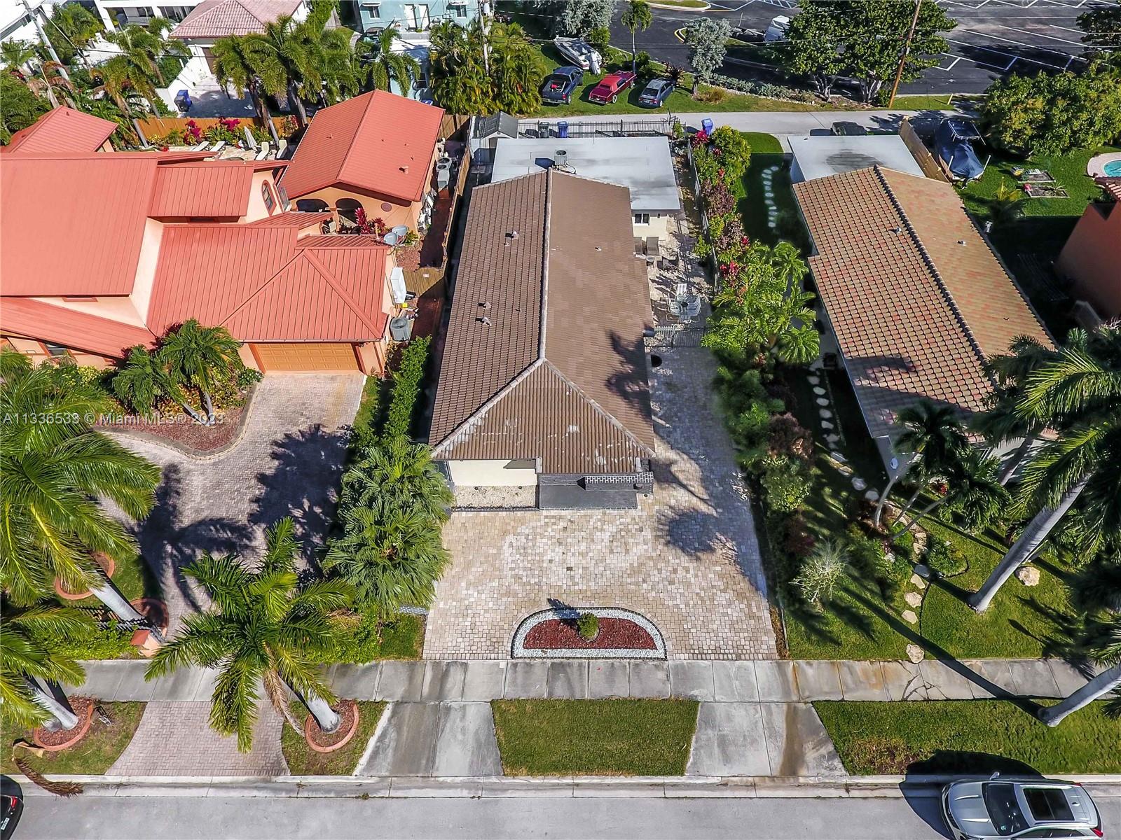 735 Tyler Street Hollywood, FL 33019 - Photo 6 of 35 an aerial view of a house with garden space and street view
