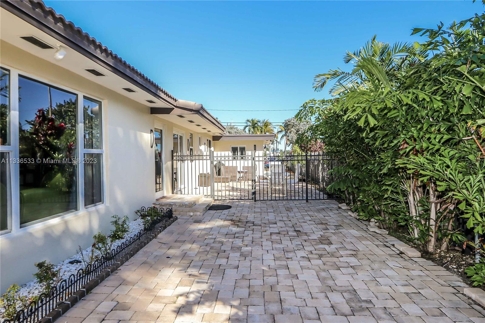 735 Tyler Street Hollywood, FL 33019 - Photo 8 of 35 a view of a house with backyard and sitting area