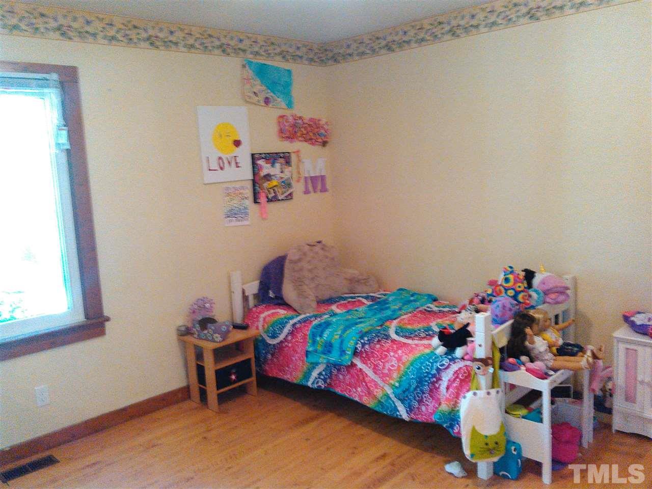 7508 Ray Road Raleigh, NC 27613 - Photo 11 of 18 a bedroom with a bed and a window