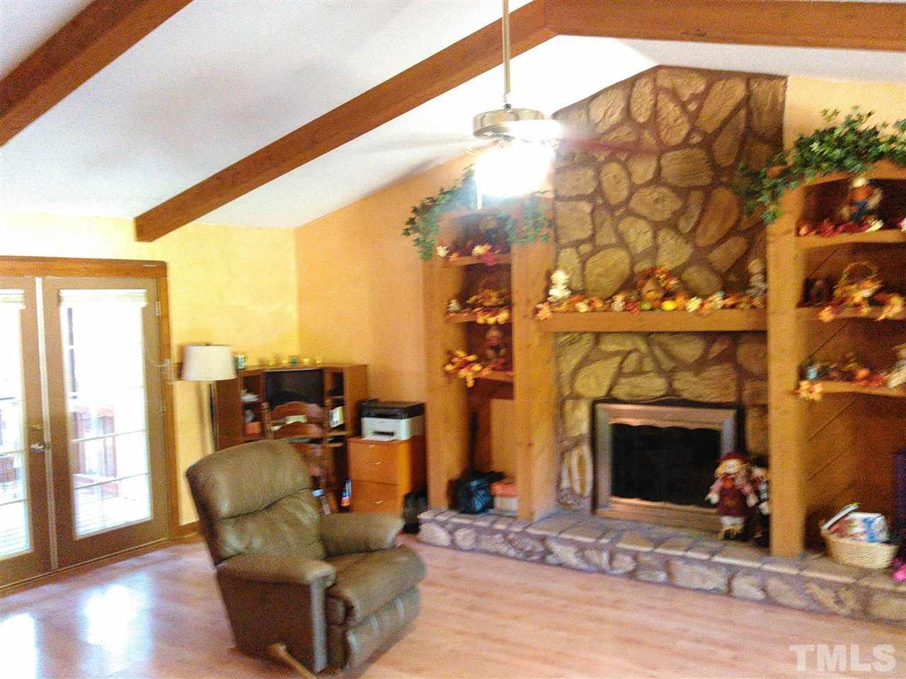7508 Ray Road Raleigh, NC 27613 - Photo 3 of 18 a living room with furniture a fireplace and city view