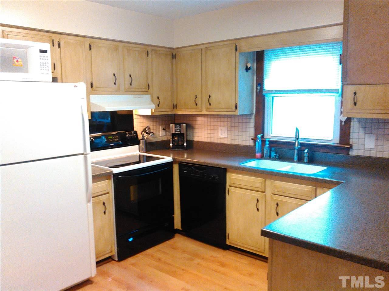 7508 Ray Road Raleigh, NC 27613 - Photo 6 of 18 a kitchen with a refrigerator and window