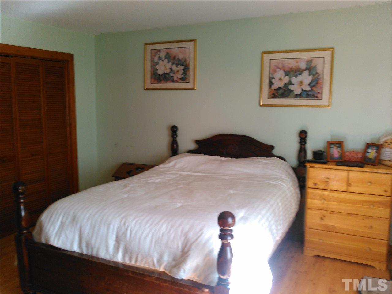 7508 Ray Road Raleigh, NC 27613 - Photo 7 of 18 a bedroom with a bed and a closet