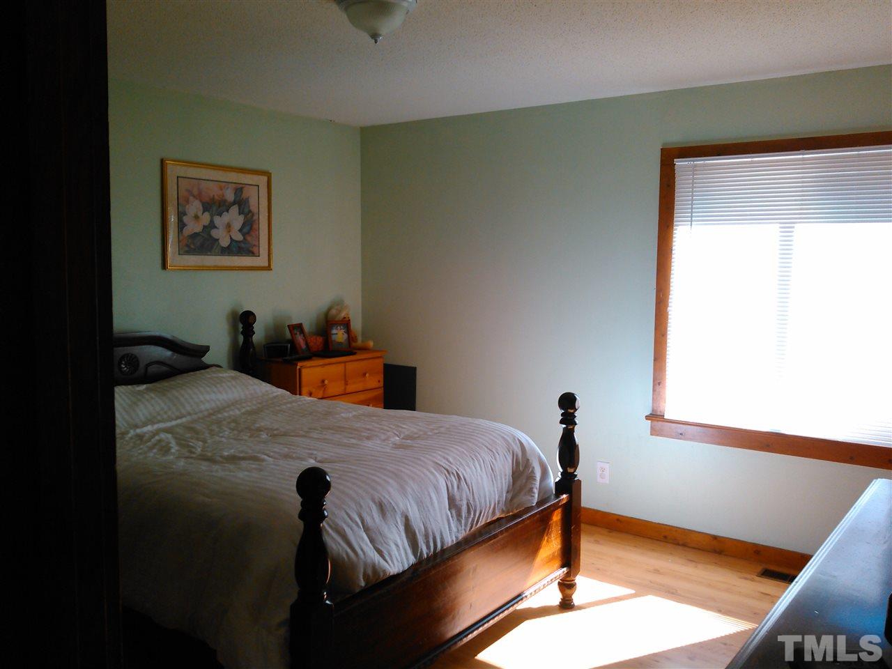 7508 Ray Road Raleigh, NC 27613 - Photo 8 of 18 a bedroom with a bed and a window