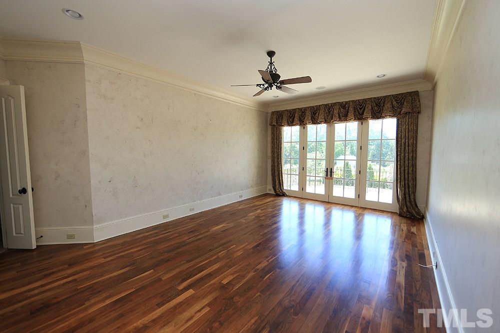 915 Ennis Road Angier, NC 27501 - Photo 14 of 30 First floor Master bedroom suite takes a wing of the home with his and hers showers, closets, dual vanities french doors, soaking tub and more