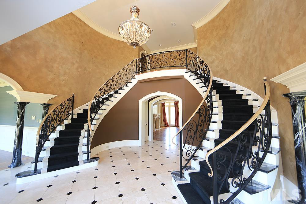 915 Ennis Road Angier, NC 27501 - Photo 3 of 30 Dual winding staircases outline the foyer, 2 story ceiling,catwalk & balcony offers sweeping views. Pillars separate both formal dining and living rooms. Views to the front entry & circular drive!