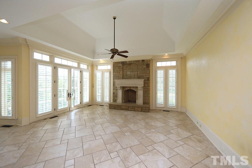 915 Ennis Road Angier, NC 27501 - Photo 6 of 30 An extension of the kitchen, cozy up to this fireplace with family and friends. Off this room is a wetroom wash off after a day in the barn or a muddy puppy from playing in pastures! Flanked by a fabulous finished 3 car garage plantation shuttters inside!