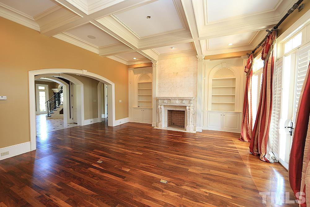 915 Ennis Road Angier, NC 27501 - Photo 7 of 30 Fabulous family room features coffered ceilings, fireplace, hardwood floors, french doors and a cozy atmosphere to settle in to after a long day of riding horses!