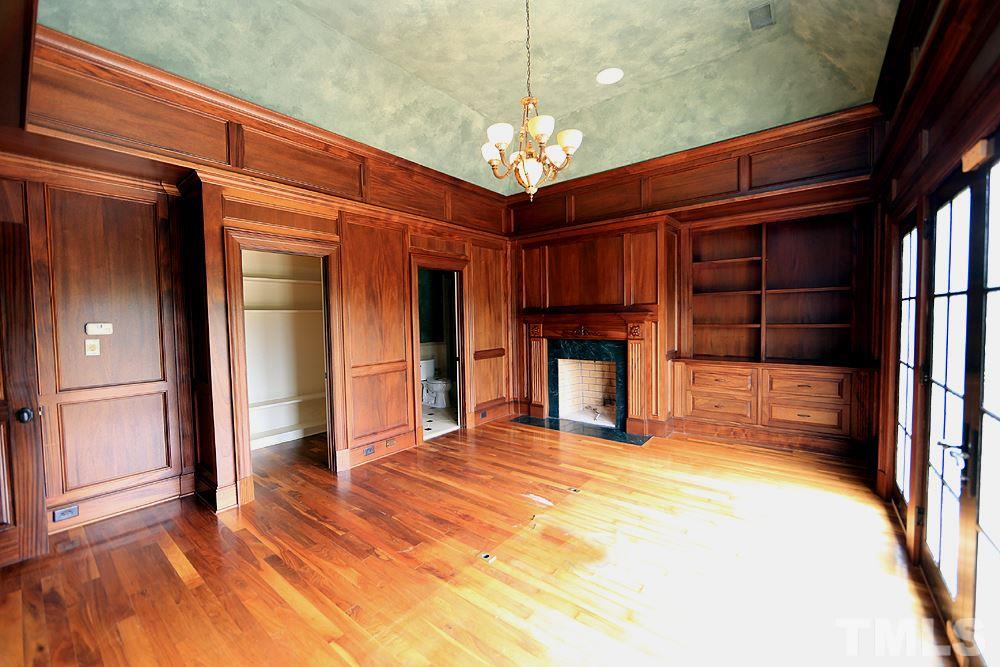 915 Ennis Road Angier, NC 27501 - Photo 9 of 30 Enjoy hardwood finishes in this stunning office! Built in bookcases,fireplace all encased in hardwood! Private office features, full walk in closet, full bath, coved ceilings, balcony with french doors overlooking back pastures-incredible details!
