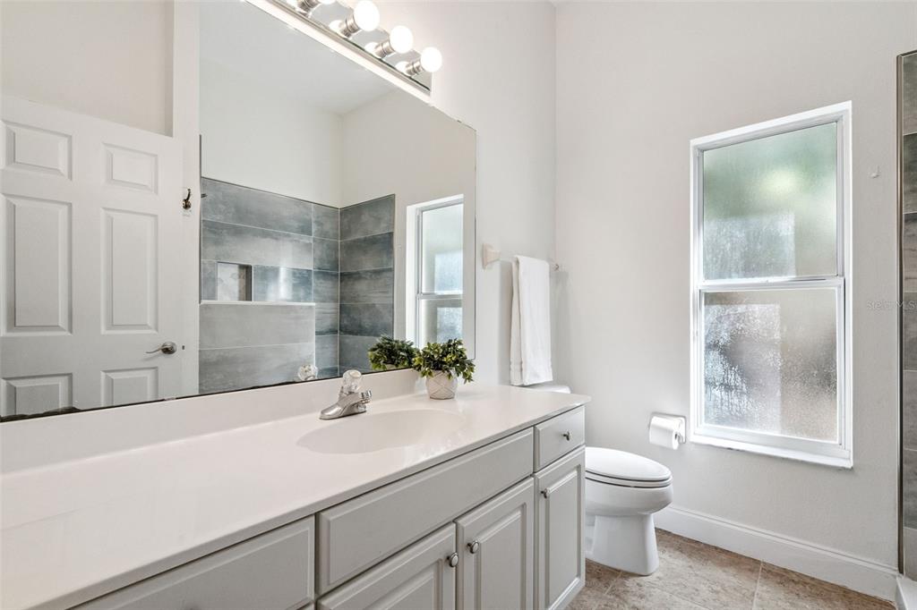 2541 Teton Stone Run Orlando, FL 32828 - Photo 40 of 82 a bathroom with a sink a toilet and shower