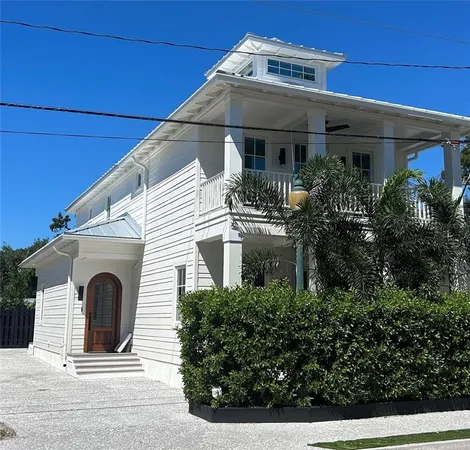 a front view of a house with garage and balcony