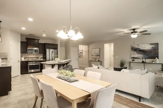 a large kitchen with a table and chairs