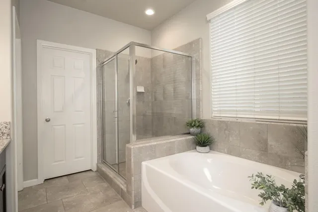 a bathroom with a bathtub and a shower