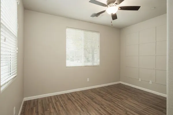 a view of a room with wooden floor and windows