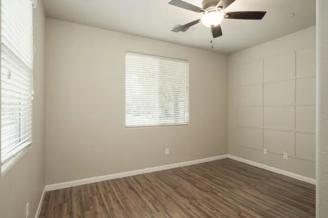 a view of a room with wooden floor and windows