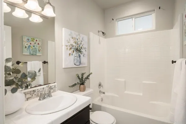 a bathroom with a sink a toilet and a bathtub