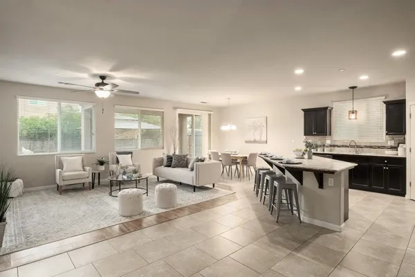 a living room with couches a dining table and kitchen view